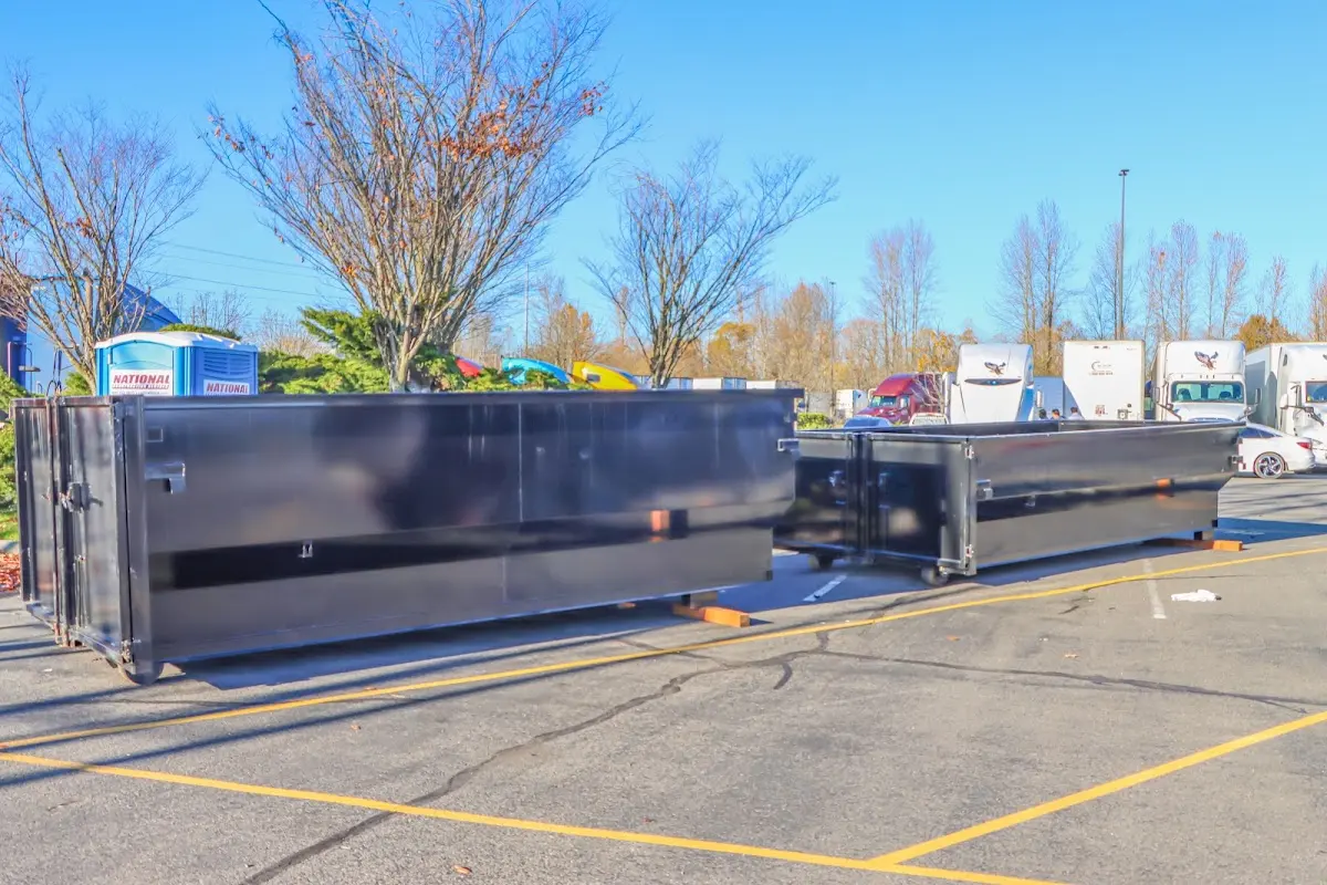 Professional dumpster rental service with roll-off container on residential driveway in Pampa